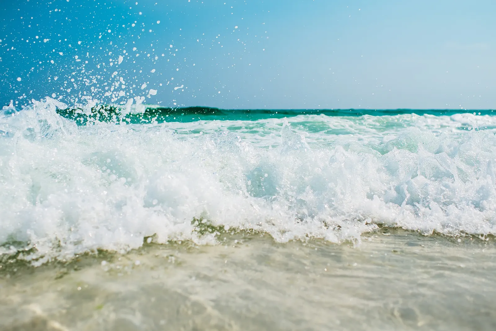 A bright tropical beach and blue ocean